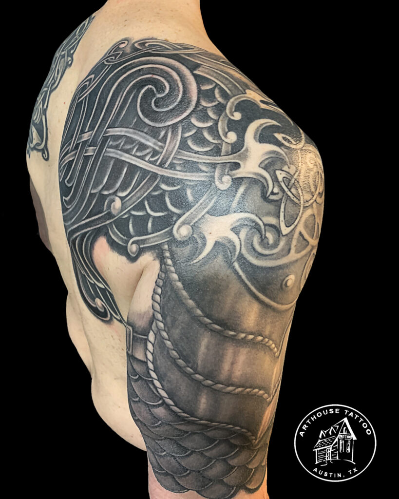 Detailed shoulder dragon tattoo on skin.