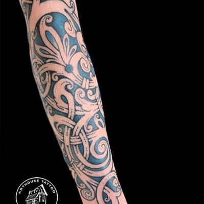 Intricate paisley pattern tattoo on forearm.