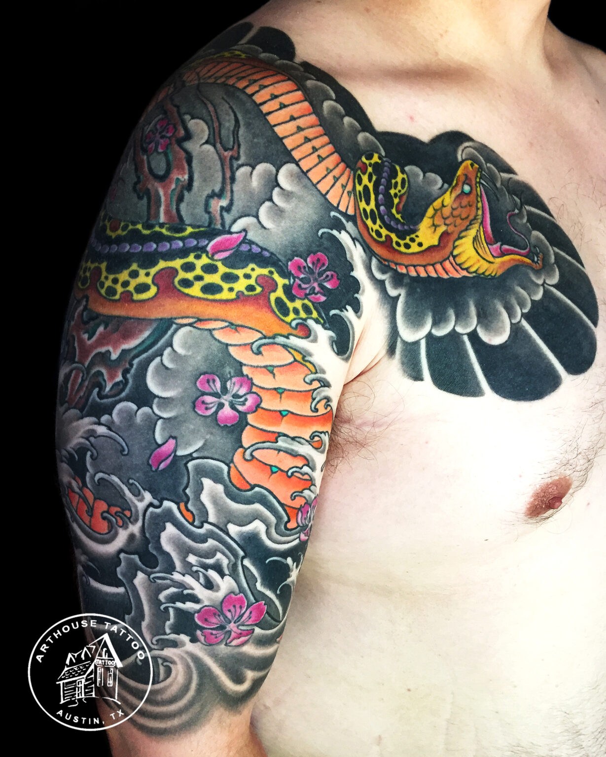 Colorful traditional snake tattoo on arm.