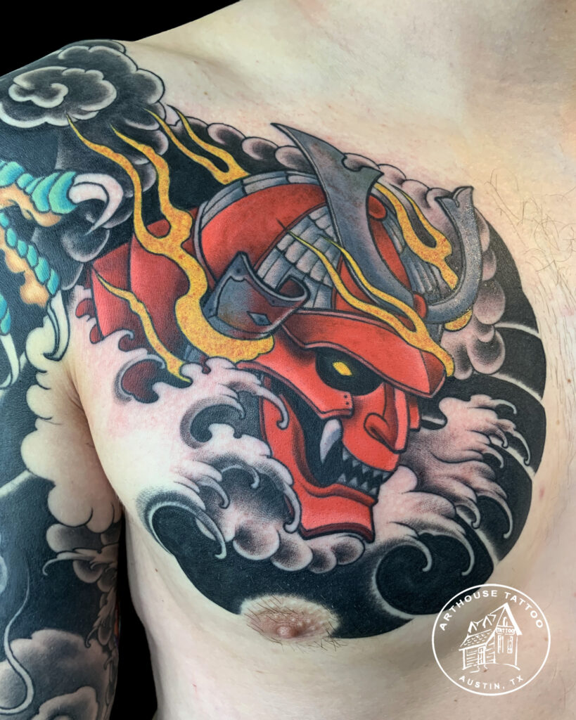 Colorful samurai helmet tattoo on shoulder.