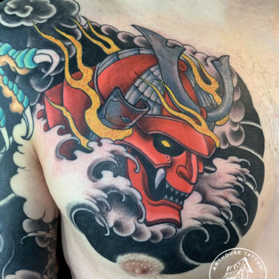 Colorful samurai helmet tattoo on shoulder.