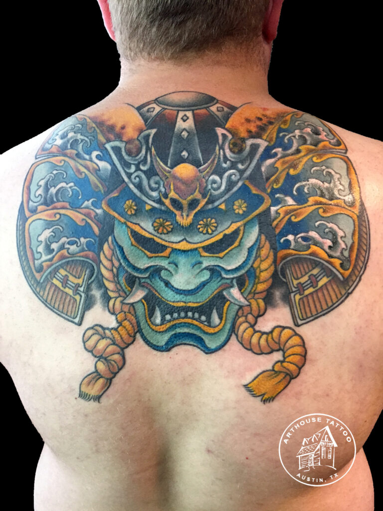 Colorful samurai helmet tattoo on back.
