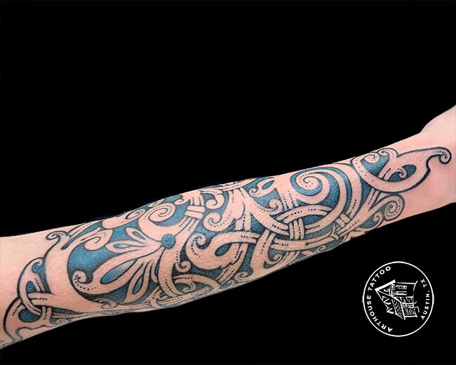 Intricate paisley pattern tattoo on forearm.